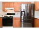 This kitchen features stainless steel appliances and warm wood cabinetry with ample storage at 32 E Main St, Mooresville, IN 46158
