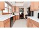 Spacious kitchen showcasing wood cabinets, black appliances and a view to another room in the home at 32 E Main St, Mooresville, IN 46158