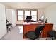 Bright office with ample natural light, wooden desk, and plenty of workspace at 32 E Main St, Mooresville, IN 46158