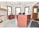Functional office space with ample natural light, a brick fireplace, and built-in storage at 32 E Main St, Mooresville, IN 46158