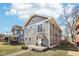 Two-story home featuring stylish gray siding, a welcoming front porch, and a well-maintained yard at 3348 Carrollton Ave, Indianapolis, IN 46205