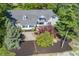 An aerial view of a home with beautiful landscaping, a large driveway, and a well-maintained lawn at 3548 W 500 North Rd, McCordsville, IN 46055