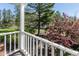 View from the balcony showing the backyard with lush greenery and mature trees at 3548 W 500 North Rd, McCordsville, IN 46055
