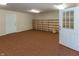 Finished basement with built in shelves, two doors, and carpet at 3548 W 500 North Rd, McCordsville, IN 46055