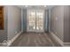 Bright living room features plush carpeting and glass paneled french doors to the outside at 3548 W 500 North Rd, McCordsville, IN 46055