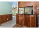 Living area with wooden cabinetry, granite countertops, a pass-through to another room, and natural lighting at 3548 W 500 North Rd, McCordsville, IN 46055