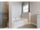 Bright bathroom features a soaking tub with tile surround, shower, and window for natural light at 3581 Free Spirit Ct, Westfield, IN 46074