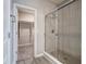 Bathroom with tiled shower, glass door, and open closet offers modern convenience at 3581 Free Spirit Ct, Westfield, IN 46074