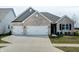 Beautiful single-story home with a three car garage and a well-manicured lawn at 3581 Free Spirit Ct, Westfield, IN 46074