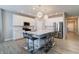 Open kitchen featuring a large island with seating, white cabinets, and stainless steel appliances at 3581 Free Spirit Ct, Westfield, IN 46074