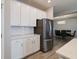 Bright kitchen with stainless steel refrigerator, white cabinets, and quartz countertops at 3581 Free Spirit Ct, Westfield, IN 46074