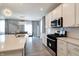 Modern kitchen and dining area featuring stainless steel appliances and stylish pendant lighting at 3581 Free Spirit Ct, Westfield, IN 46074