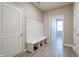 Hallway with built-in bench, gray walls, white trim, white doors and wood-look flooring at 3581 Free Spirit Ct, Westfield, IN 46074