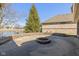Backyard patio features a fire pit and scenic view of the pond and home's brick exterior at 3792 Waterfront Way, Plainfield, IN 46168