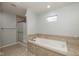 Bathroom featuring a soaking tub with tile surround and a glass-enclosed shower at 3792 Waterfront Way, Plainfield, IN 46168