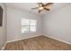 Bedroom with a ceiling fan, wood-look flooring, and a window with blinds at 3792 Waterfront Way, Plainfield, IN 46168