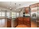 Well-appointed kitchen featuring dark wood cabinets, stainless steel appliances, and a breakfast bar overlooking the living area at 3792 Waterfront Way, Plainfield, IN 46168