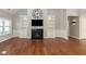 Comfortable living room featuring a fireplace, custom built-ins, and stylish hardwood floors at 3792 Waterfront Way, Plainfield, IN 46168