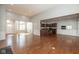 Open concept living space with hardwood floors flowing seamlessly between the living, dining, and kitchen areas at 3792 Waterfront Way, Plainfield, IN 46168