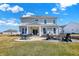 Inviting backyard featuring a patio, outdoor dining set, and a cozy fire pit area with Adirondack chairs at 4052 Saddle Club S Pkwy, Bargersville, IN 46106