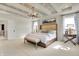 Bright main bedroom featuring a tray ceiling, chandelier, and carpet at 4052 Saddle Club S Pkwy, Bargersville, IN 46106