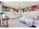 Bright bedroom featuring floral accent wall, modern lighting, and large windows with a dresser near the bed at 4052 Saddle Club S Pkwy, Bargersville, IN 46106