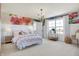 Cozy bedroom featuring floral accent wall, modern lighting, and large windows with picturesque view at 4052 Saddle Club S Pkwy, Bargersville, IN 46106