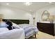 Comfortable bedroom with a cozy bed, dark green wainscoting, and matching wooden dresser at 4052 Saddle Club S Pkwy, Bargersville, IN 46106