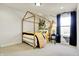 Well-lit bedroom with a gold frame bed, jungle-themed wall art, and dark window drapes at 4052 Saddle Club S Pkwy, Bargersville, IN 46106