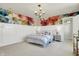 Bright bedroom featuring floral accent wall, modern lighting, and large windows with an en suite closet at 4052 Saddle Club S Pkwy, Bargersville, IN 46106