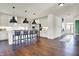 Open-concept kitchen features a center island, modern appliances, and hardwood floors at 4052 Saddle Club S Pkwy, Bargersville, IN 46106