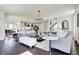 A modern living room features neutral furniture, stylish lighting, and an open connection to kitchen at 4052 Saddle Club S Pkwy, Bargersville, IN 46106