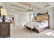 Bright, spacious main bedroom features tray ceiling with decorative beams, modern lighting, and neutral color palette at 4052 Saddle Club S Pkwy, Bargersville, IN 46106