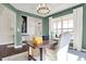 Stylish home office with custom woodwork, large windows, and designer chandelier at 4052 Saddle Club S Pkwy, Bargersville, IN 46106