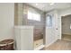 Modern bathroom features a walk-in shower with glass enclosure, wood-look tiles, and a rain shower head at 4052 Saddle Club S Pkwy, Bargersville, IN 46106