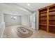 The basement features neutral walls, tiled floor and built-in wooden shelving at 4448 Aristocrat Cir, Indianapolis, IN 46235