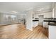 Open-concept living area featuring hardwood floors, staircase, white cabinets, and recessed lighting at 4448 Aristocrat Cir, Indianapolis, IN 46235