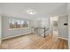 Well-lit open-concept living area featuring hardwood floors and updated lighting at 4448 Aristocrat Cir, Indianapolis, IN 46235