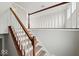 Interior staircase showing wooden handrail and white balusters, and updated flooring at 4448 Aristocrat Cir, Indianapolis, IN 46235