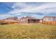 Expansive back yard featuring a well-maintained lawn and a charming brick home with a covered patio at 4720 W Tradwell Dr, New Palestine, IN 46163