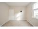Bright empty bedroom featuring neutral walls, carpet, and a window, offering a clean and versatile space at 4720 W Tradwell Dr, New Palestine, IN 46163