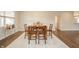 A cozy dining room with hardwood floors, a modern rug, and a wooden table with seating for six at 4720 W Tradwell Dr, New Palestine, IN 46163