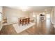 Open-concept dining area with a chandelier, wooden table, and chairs at 4720 W Tradwell Dr, New Palestine, IN 46163