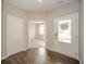 Bright foyer featuring hardwood floors, neutral paint, and entry to a bedroom at 4720 W Tradwell Dr, New Palestine, IN 46163