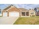 Charming single-story brick home with a three-car garage and well-maintained lawn at 4720 W Tradwell Dr, New Palestine, IN 46163