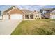 Charming single-story brick home with a three-car garage and well-maintained lawn at 4720 W Tradwell Dr, New Palestine, IN 46163
