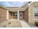 Inviting covered porch with stone accents and a decorative front door at 4720 W Tradwell Dr, New Palestine, IN 46163
