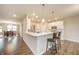 Bright kitchen features white cabinets, quartz countertops, and an open floor plan to the dining room at 4720 W Tradwell Dr, New Palestine, IN 46163