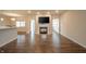 Open concept space with hardwood floors, fireplace, and views to the kitchen and dining areas at 4720 W Tradwell Dr, New Palestine, IN 46163