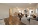 Comfortable living room featuring hardwood floors, fireplace, recessed lighting, and modern furnishings at 4720 W Tradwell Dr, New Palestine, IN 46163